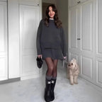 Women's knit sweater and skirt outfit set in soft cotton, featuring a relaxed fit and matching design for effortless style.