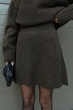 Cozy women's knit sweater and skirt outfit set in soft fabric, featuring a classic crew neckline and a flattering A-line…