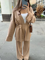 Women's knitted cardigan and pants set featuring a belted design in soft, breathable fabric for comfort and style.