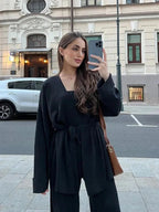 Women's knitted cardigan and pants set in soft fabric, featuring a belted design and comfortable fit for everyday wear.