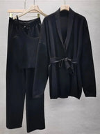 Women's knitted cardigan and pants set featuring a belted design in a soft, comfortable fabric for everyday wear.