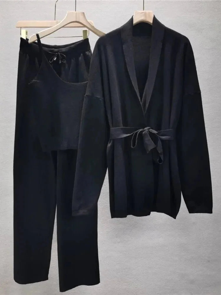 Women's knitted cardigan and pants set featuring a belted design in a soft, comfortable fabric for everyday wear.