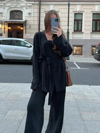 Women's knitted cardigan and pants set featuring a belted waist and cozy texture, perfect for casual or layered looks.