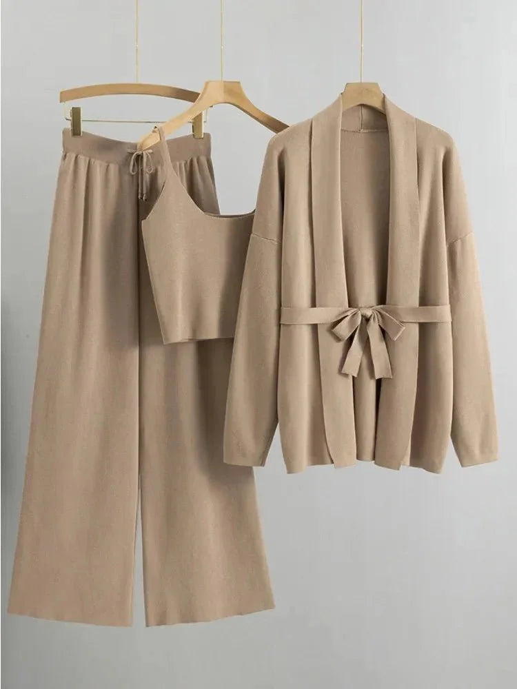 Women's knitted cardigan and pants set in soft fabric, featuring a belted design for a flattering silhouette.