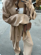 Women's knitted cardigan and pants set with a belted waist, featuring soft fabric and a cozy design for everyday wear.