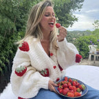 Women's knitted cardigan with strawberry pattern, made of soft cotton blend, features ribbed cuffs and an open front design.