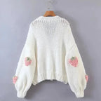 Women's knitted cardigan featuring a playful strawberry pattern, made from soft, breathable cotton blend for comfort.