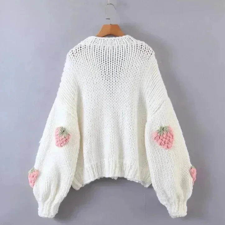 Women's knitted cardigan featuring a playful strawberry pattern, made from soft, breathable cotton blend for comfort.