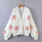 Women's knitted cardigan featuring a playful strawberry pattern, crafted from soft, breathable cotton for everyday comfort.