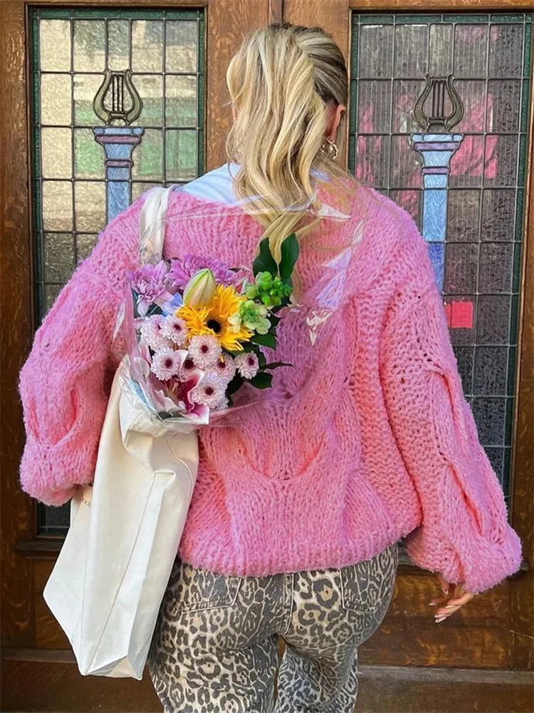 Lightweight women's knitted casual sweater with a loose fit, featuring ribbed edges and a soft, breathable fabric.