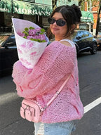 Women's loose-fit knitted sweater made from soft, breathable fabric, featuring a cozy design for everyday wear.