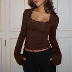 Women's long sleeve top with lace trim, made from soft cotton blend for comfort and elegant style. Perfect for layering.