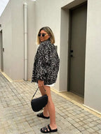 Women's leopard print bomber jacket made of lightweight polyester with ribbed cuffs and a zip front for casual styling.