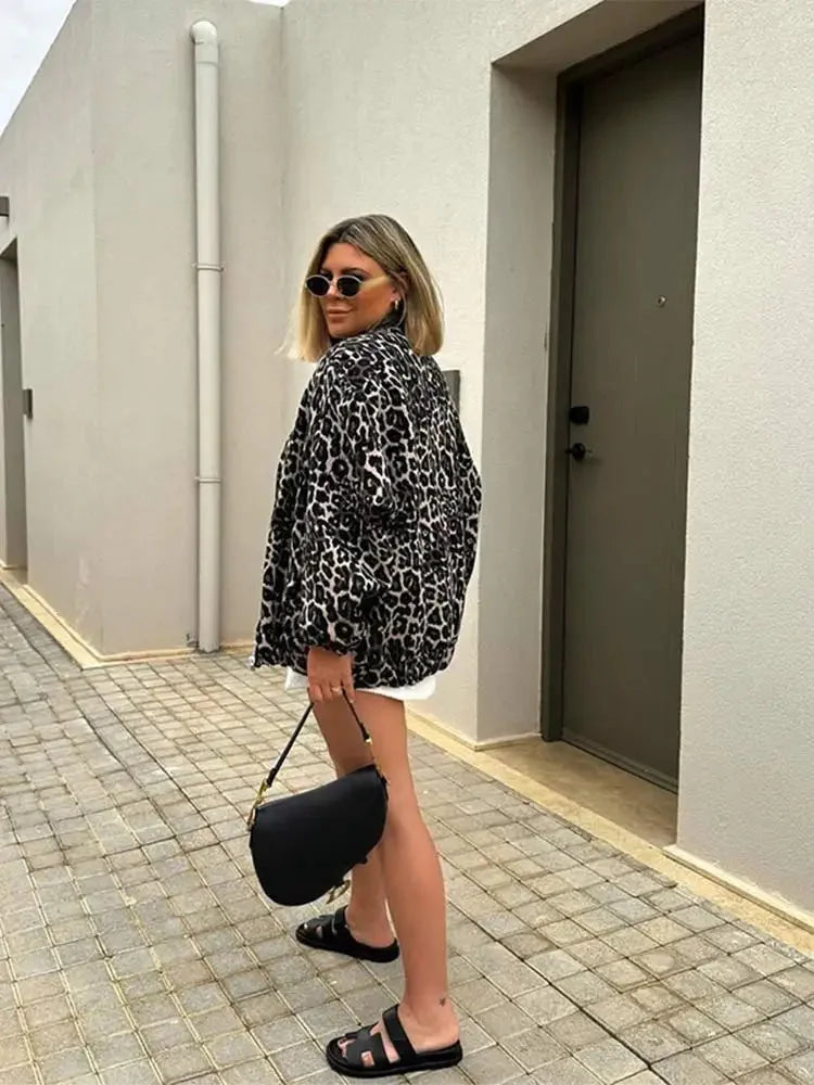 Women's leopard print bomber jacket made of lightweight polyester with ribbed cuffs and a zip front for casual styling.
