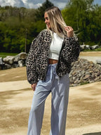 Alt text: Women's bomber jacket featuring a trendy leopard print design, made from soft polyester fabric with ribbed cuffs.