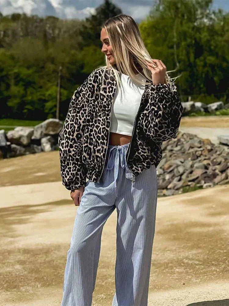 Alt text: Women's bomber jacket featuring a trendy leopard print design, made from soft polyester fabric with ribbed cuffs.