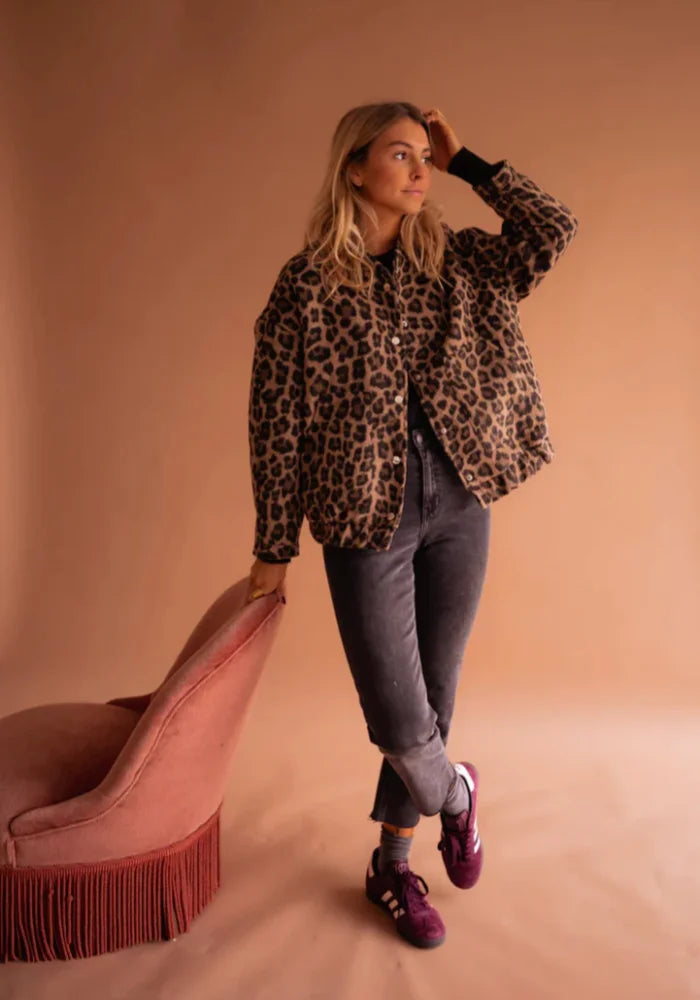Women's leopard print button-up jacket made from soft cotton blend with a classic collar and two front pockets.