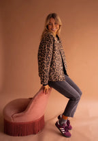 Women's leopard print button-up jacket featuring soft fabric, long sleeves, and a classic collar for a stylish casual look.