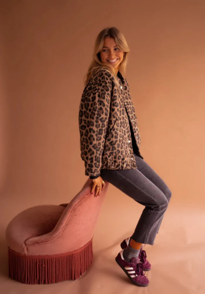 Women's leopard print button-up jacket featuring soft fabric, long sleeves, and a classic collar for a stylish casual look.