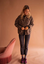 Women's leopard print button-up jacket made of soft, breathable fabric with a playful design and functional front pockets.