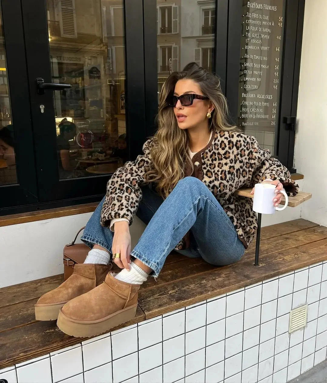 Women's leopard print cardigan with button-up front, featuring soft fabric and a stylish, trendy design.
