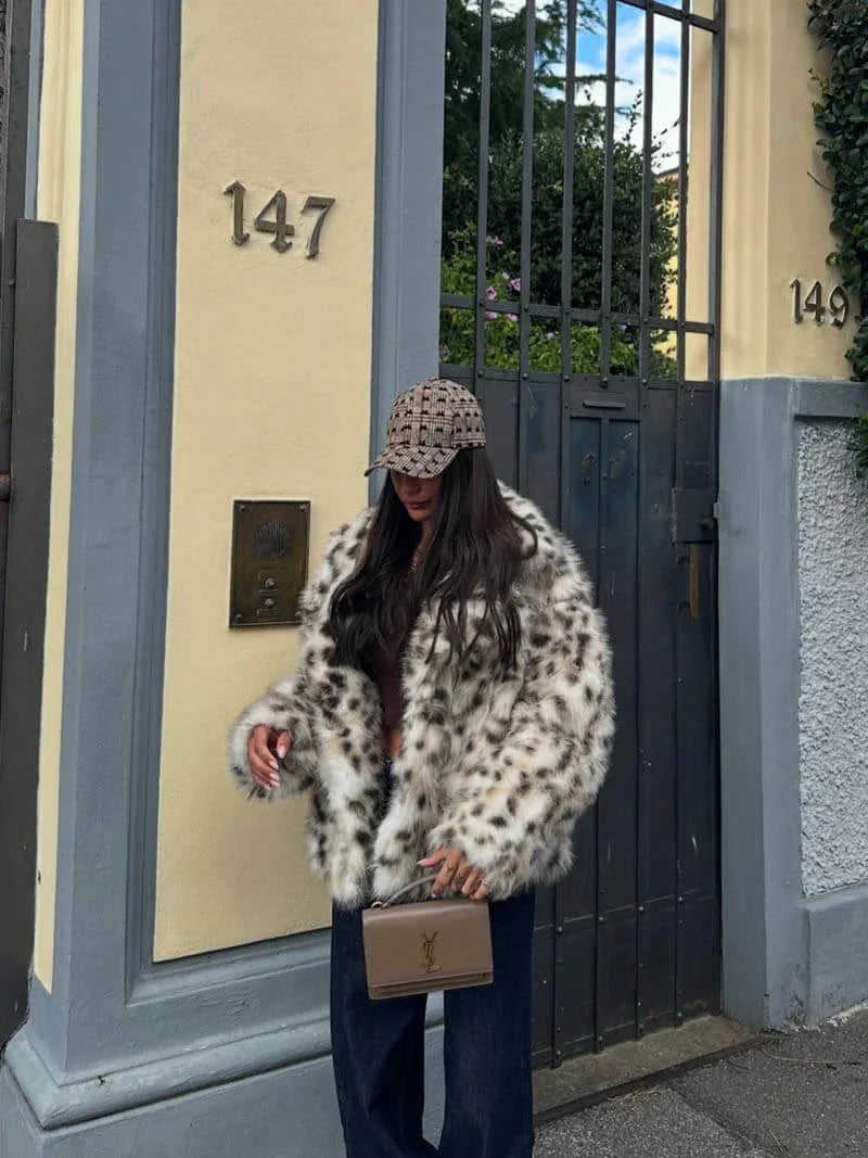 Women's leopard print faux fur jacket featuring long sleeves, soft material, and a trendy animal print design.