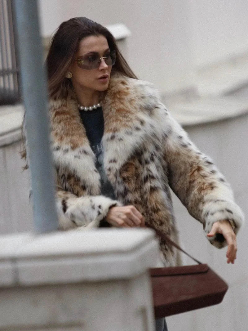 Women's leopard print faux fur jacket featuring long sleeves and a cozy, casual design for added warmth and style.