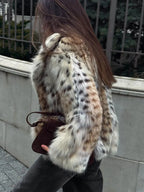 Alt text: Women's leopard print faux fur jacket with long sleeves, featuring a soft texture and trendy animal pattern.