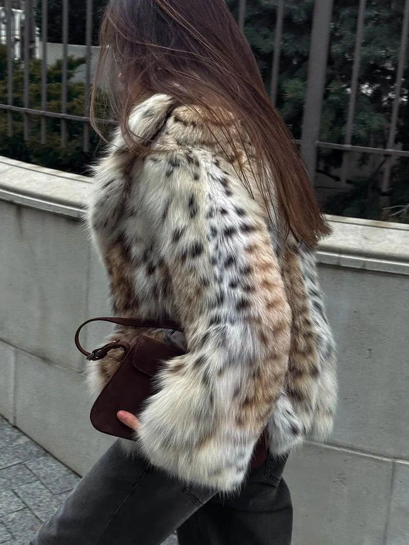 Alt text: Women's leopard print faux fur jacket with long sleeves, featuring a soft texture and trendy animal pattern.