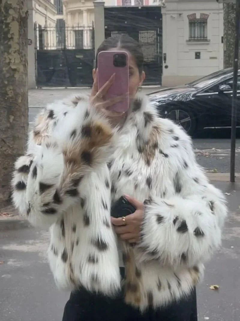 Women's leopard print faux fur jacket featuring long sleeves and a soft, textured finish for warmth and style.