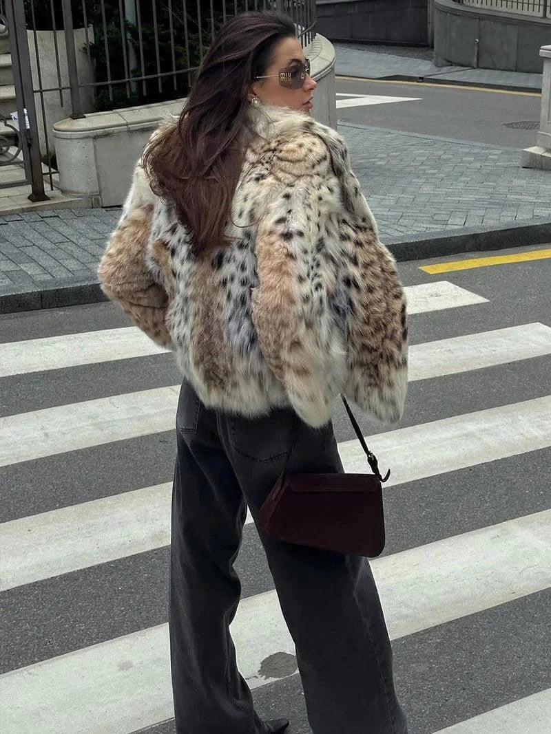 Women's leopard print faux fur jacket featuring long sleeves and a soft texture, perfect for style and warmth.