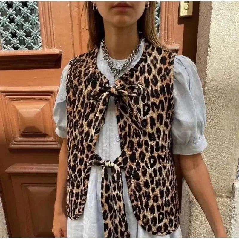 Women's leopard print vest featuring bow tie accents, soft fabric, and a stylish open front design for a trendy look.