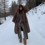 Women's long faux fur coat in soft, fluffy material with a cozy design, ideal for winter warmth and style.