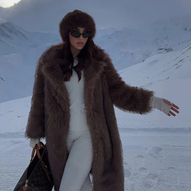 Women's long faux fur coat made of soft, fluffy material with a stylish and warm winter outerwear design.