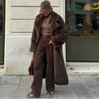 Women's long faux fur coat in soft, fluffy material, featuring a classic design with button closure and side pockets for…