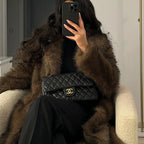 Women's long faux fur coat in soft, fluffy material; features a sleek design and warm winter-ready outerwear style.