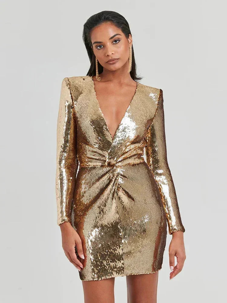 Women's long-sleeve mini dress with gold sequins, featuring a fitted silhouette and a round neckline for an elegant look.