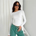 Women's long sleeve slim fit pullover top in soft cotton, featuring a classic crew neck and ribbed cuffs for a streamlined…