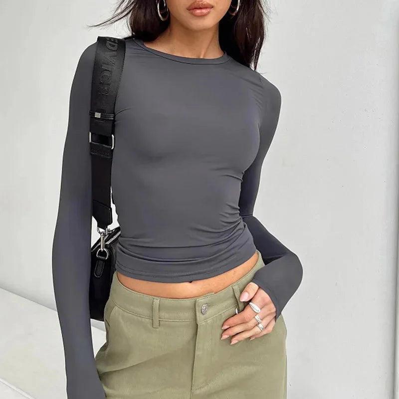 Women's long sleeve slim fit pullover top made of soft cotton blend, featuring a casual scoop neck and fitted silhouette.