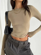 Women's long sleeve slim fit pullover top in soft cotton blend, featuring a ribbed neckline and casual silhouette for…