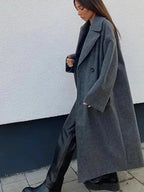 Women's long structured coat in a relaxed fit, made from durable fabric with a stylish oversized design and practical…