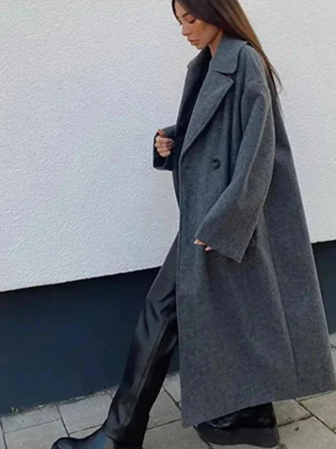 Women's long structured coat in a relaxed fit, made from durable fabric with a stylish oversized design and practical…