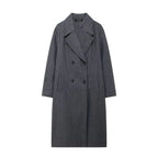 Women's long structured coat in a relaxed fit, made from durable fabric with oversized sleeves and a tailored silhouette.