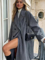 Above-the-knee structured coat for women, featuring an oversized fit, made from durable fabric with a tailored silhouette.