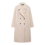 Women's long structured coat with an oversized fit, featuring durable fabric, wide sleeves, and angled pockets for added…