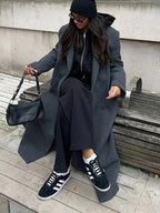 Women's long structured coat in soft wool blend, featuring an oversized fit and tailored silhouette for a modern look.
