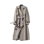 Women's long trench coat in breathable fabric with a belted waist and classic lapels, perfect for stylish layering.