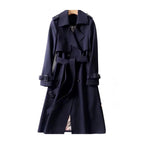 Women's long trench coat in durable fabric, featuring a belted waist and classic lapels for a timeless silhouette.