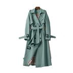 Women's long trench coat in durable fabric, featuring a belted waist and stylish lapels for a classic silhouette.