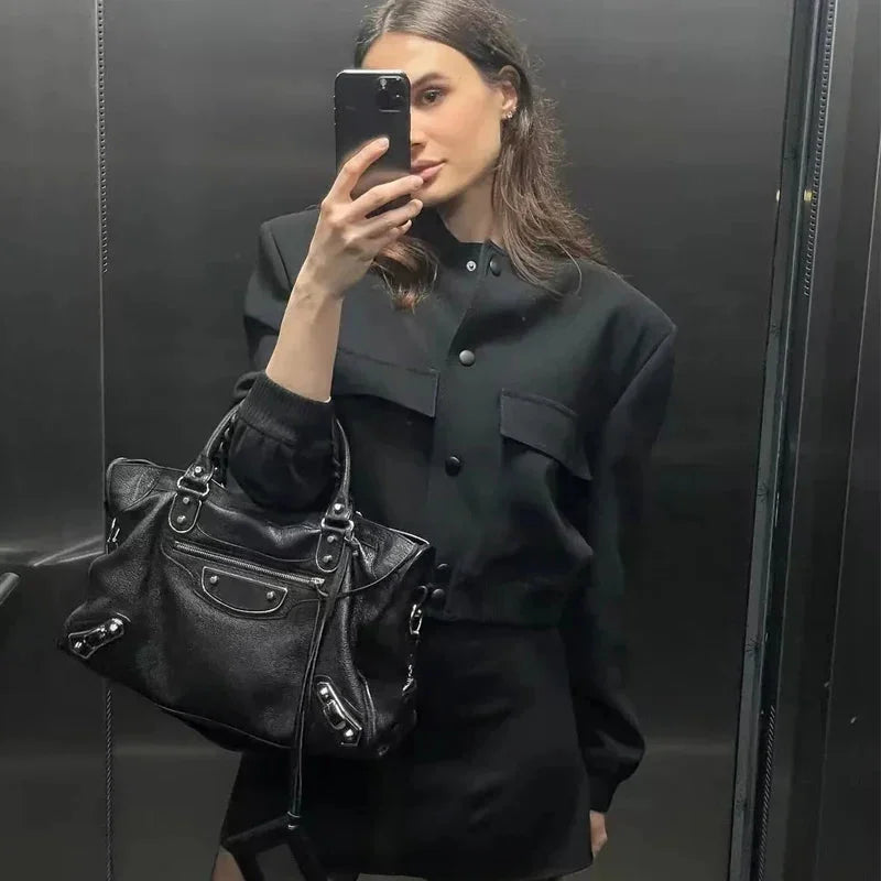 Women's bomber jacket made from lightweight fabric, featuring a sleek design and practical front pockets for everyday use.
